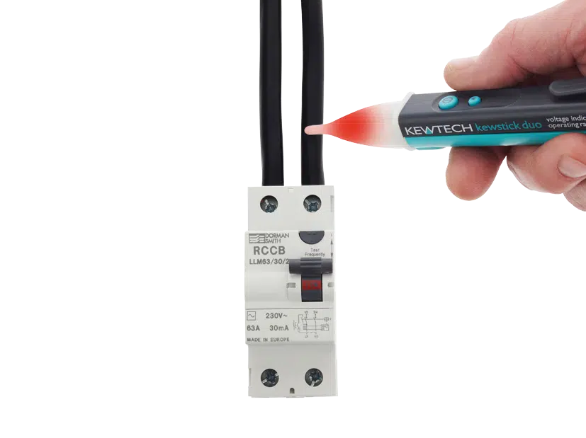 Electrician using a Kewtech Kewstick Duo non-contact voltage detector to identify live electrical cables